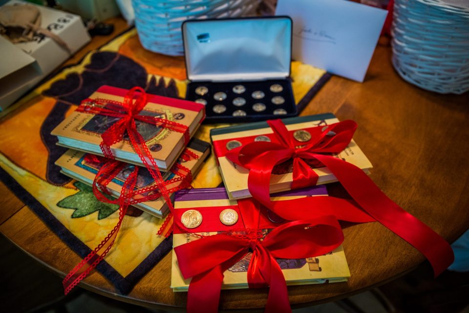 A composition of several books and decorative objects on a wooden table.