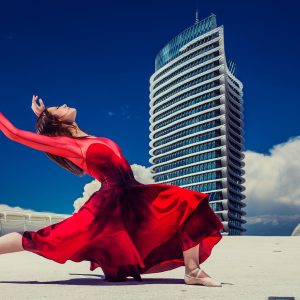 Glamour editorial photograph in an open urban setting.