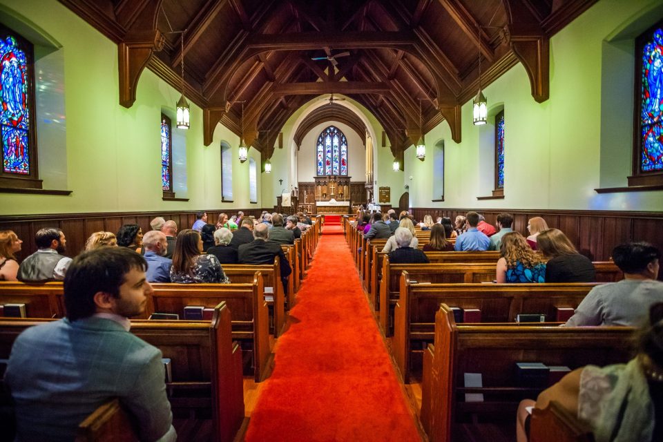 The interior of a church with an ornate wooden ceiling.