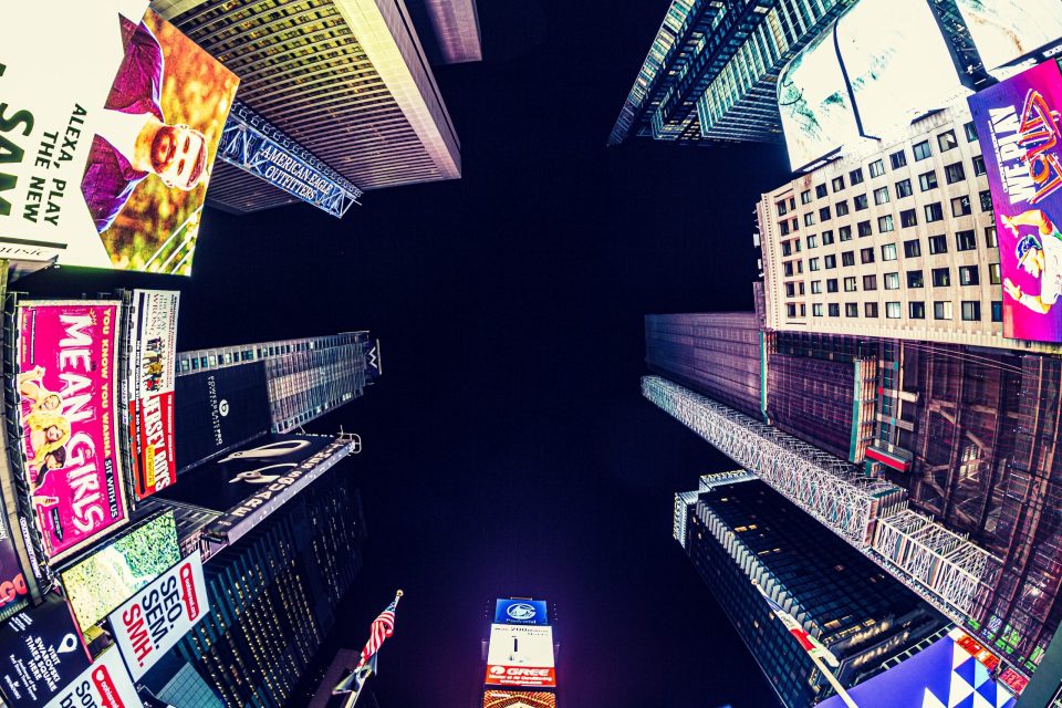 An urban nightscape photographed from street level.