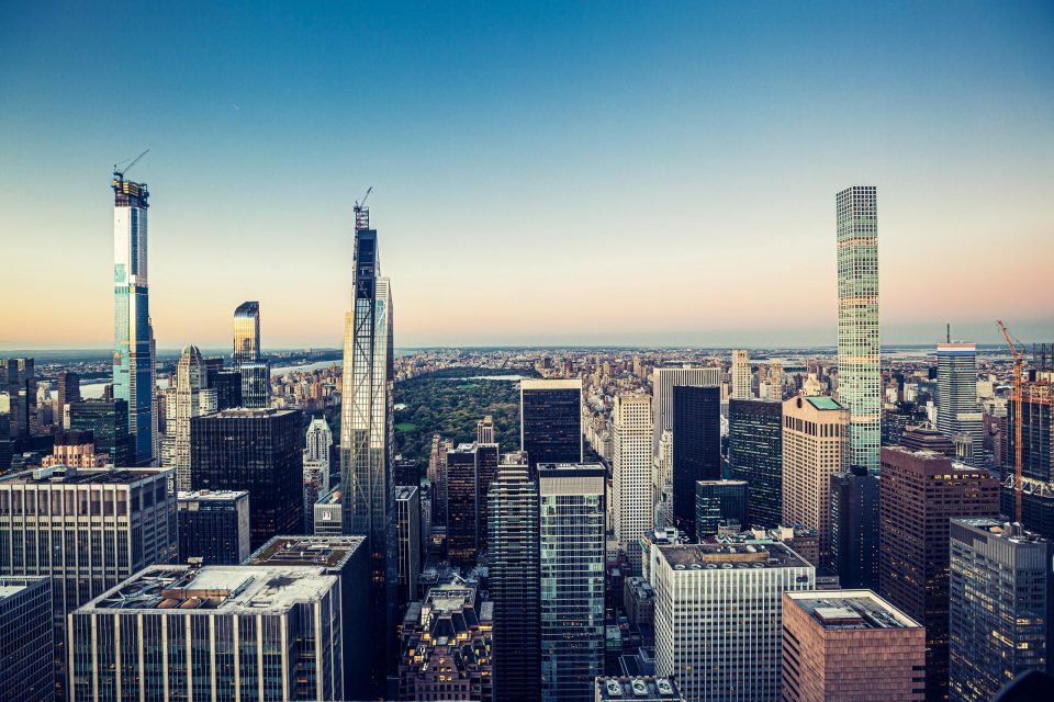 An urban panorama at sunset with numerous skyscrapers.