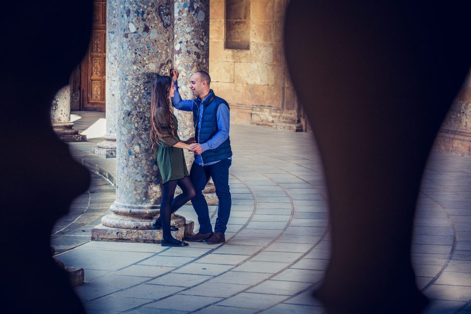 A couple poses inside a historic building.