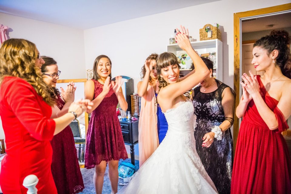 Several women celebrate together in a room.