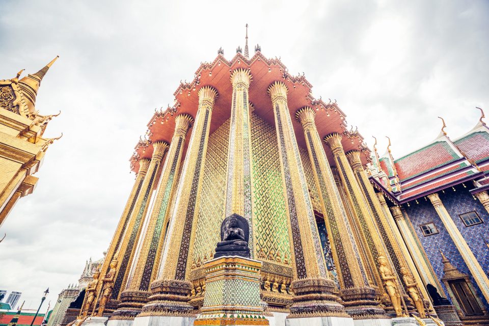 Low-angle view of the richly ornamented façade of a Buddhist temple.
