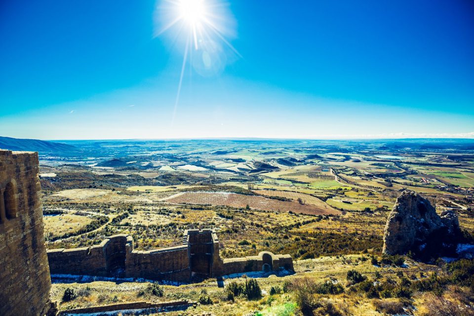 A panoramic view of an agricultural valley from an old stone fortification.